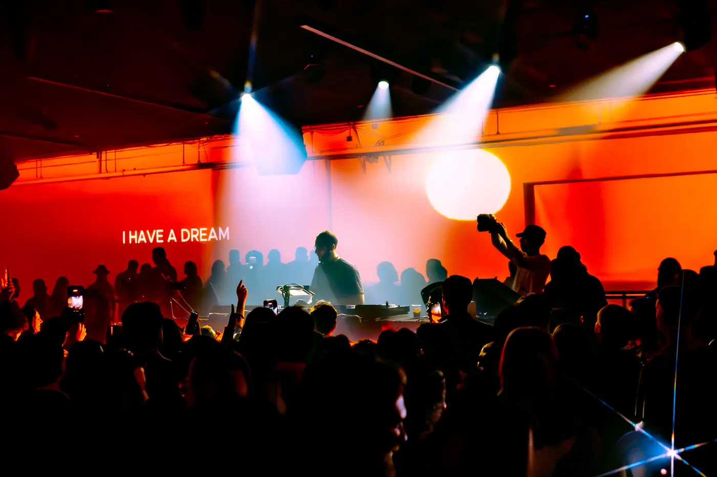 Projected typography on the wall behind the DJ booth at a Reunion event